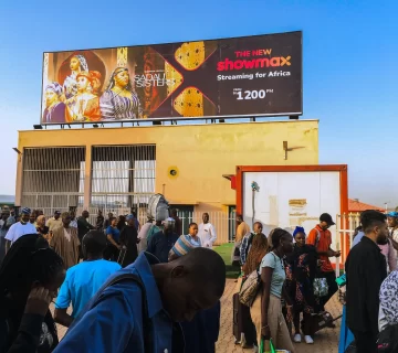 A billboard advertising Showmax 2.0 on a rooftop at the Rigasa Train Station