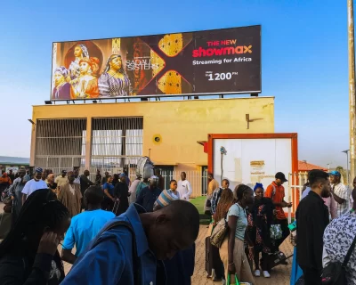 A billboard advertising Showmax 2.0 on a rooftop at the Rigasa Train Station