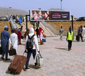 A billboard advertising Showmax 2.0 at the Kubwa Train Station Gantry