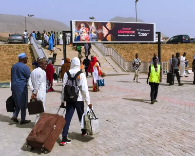 A billboard advertising Showmax 2.0 at the Kubwa Train Station Gantry